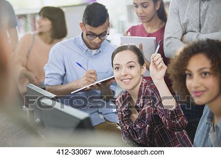 College student raising hand in computer lab classroom View Large Photo Image Stock Photo - College student raising hand in computer lab classroom. Fotosearch