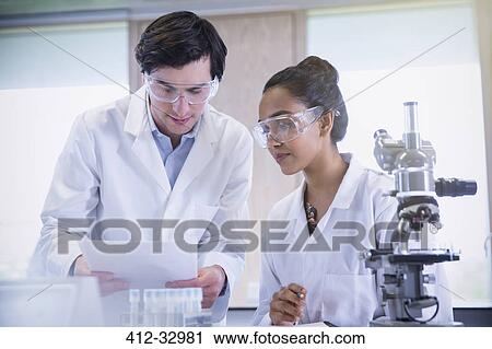 College students conducting scientific experiment at microscope in science laboratory classroom View Large Photo Image Stock Image - College students conducting scientific experiment at microscope in science laboratory classroom. Fotosearch