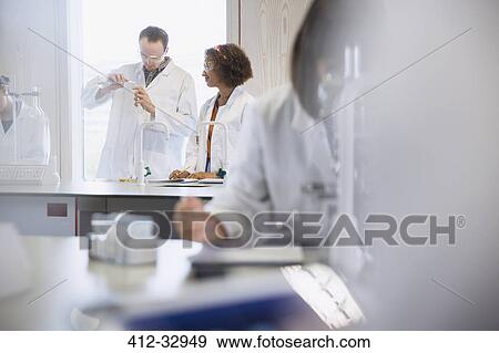 College students conducting scientific experiment in science laboratory classroom View Large Photo Image Stock Photo - College students conducting scientific experiment in science laboratory classroom. Fotosearch