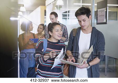 College students discussing homework in corridor View Large Photo Image Stock Photo - College students discussing homework in corridor. Fotosearch