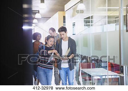 College students discussing homework in corridor View Large Photo Image Stock Photo - College students discussing homework in corridor. Fotosearch