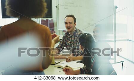 Stock Photo - College students listening to professor in classroom. Fotosearch