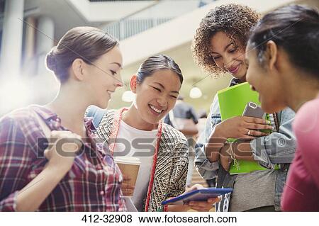 College students looking at cell phone View Large Photo Image Stock Photo - College students looking at cell phone. Fotosearch