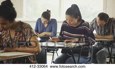 College students taking test at desk in classroom View Large Photo Image Picture - College students taking test at desk in classroom. Fotosearch