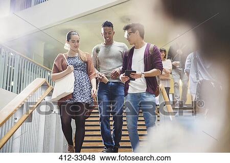 Stock Photo - College students talking and descending stairway. Fotosearch