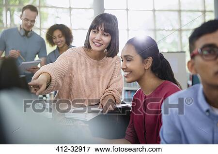 Stock Photo - College students talking in classroom. Fotosearch