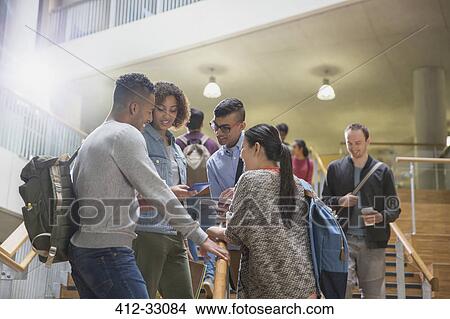 Picture - College students talking in stairway. Fotosearch