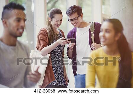 College students texting with cell phone View Large Photo Image Stock Photo - College students texting with cell phone. Fotosearch