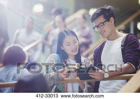 College students using digital tablet in stairway View Large Photo Image Stock Image - College students using digital tablet in stairway. Fotosearch