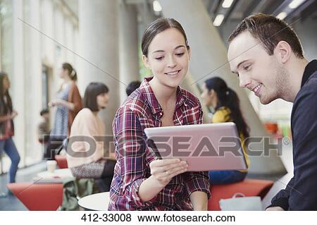 College students using digital tablet in commons View Large Photo Image Stock Photo - College students using digital tablet in commons. Fotosearch