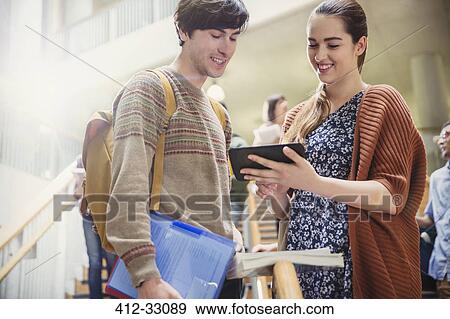 College students using digital tablet in stairway View Large Photo Image Stock Photo - College students using digital tablet in stairway. Fotosearch