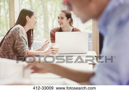 College students using laptop and drinking coffee View Large Photo Image Stock Photo - College students using laptop and drinking coffee. Fotosearch