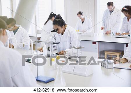 College students using microscope conducting scientific experiment in laboratory View Large Photo Image Stock Photo - College students using microscope conducting scientific experiment in laboratory. Fotosearch