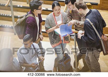 Stock Photograph - College students with coffee discussing homework. Fotosearch