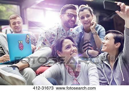College students with laptop taking selfie with camera phone View Large Photo Image Stock Image - College students with laptop taking selfie with camera phone. Fotosearch