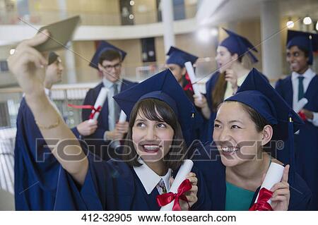 College women graduates in cap and gown taking selfie with diplomas View Large Photo Image Stock Photography - College women graduates in cap and gown taking selfie with diplomas. Fotosearch