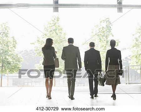 Stock Photo - Corporate business people walking in a row. Fotosearch
