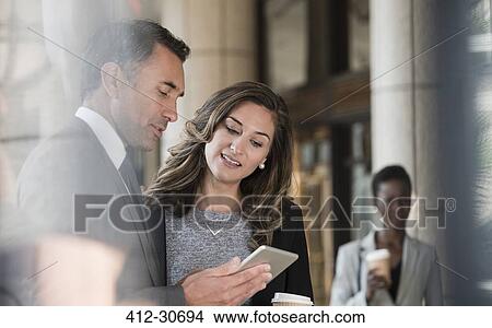 Corporate businessman and businesswoman using digital tablet View Large Photo Image Picture - Corporate businessman and businesswoman using digital tablet. Fotosearch