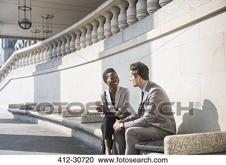 Corporate businessman and businesswoman enjoying coffee break on sunny stairs View Large Photo Image Stock Image - Corporate businessman and businesswoman enjoying coffee break on sunny stairs. Fotosearch