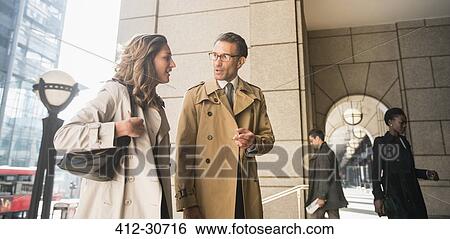 Stock Photograph - Corporate businessman and businesswoman talking outdoors. Fotosearch