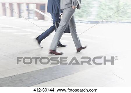Corporate businessmen walking outdoors View Large Photo Image Picture - Corporate businessmen walking outdoors. Fotosearch
