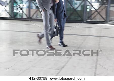 Corporate businessmen walking View Large Photo Image Stock Photo - Corporate businessmen walking. Fotosearch