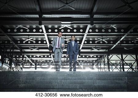 Corporate businessmen with coffee descending modern stairs View Large Photo Image Stock Photograph - Corporate businessmen with coffee descending modern stairs. Fotosearch