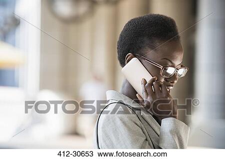 Stock Image - Corporate businesswoman talking on cell phone. Fotosearch