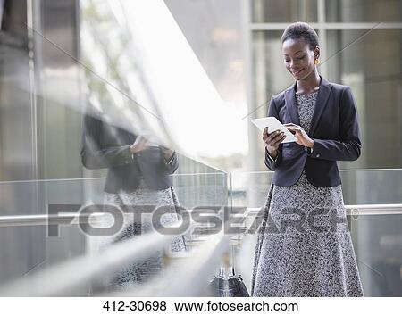 Corporate businesswoman using digital tablet View Large Photo Image Stock Photo - Corporate businesswoman using digital tablet. Fotosearch