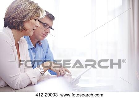 Stock Image - Couple using digital tablet. Fotosearch