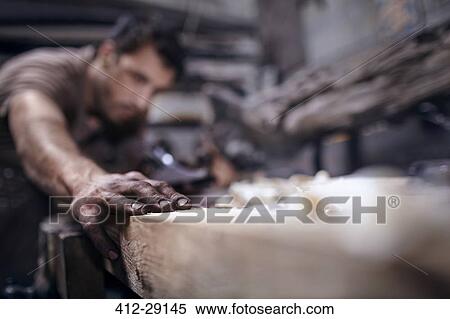 Craftsman chiseling wood in workshop View Large Photo Image Stock Photography - Craftsman chiseling wood in workshop. Fotosearch