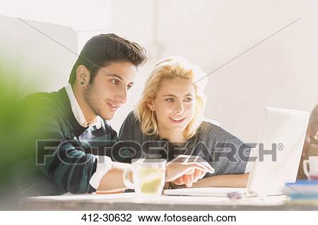 Creative young business people working at laptop View Large Photo Image Stock Image - Creative young business people working at laptop. Fotosearch
