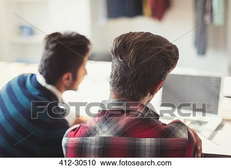 Creative young businessmen working at laptop View Large Photo Image Stock Image - Creative young businessmen working at laptop. Fotosearch