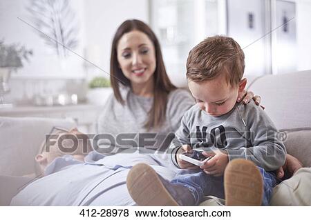 Curious toddler using cell phone View Large Photo Image Stock Photo - Curious toddler using cell phone. Fotosearch