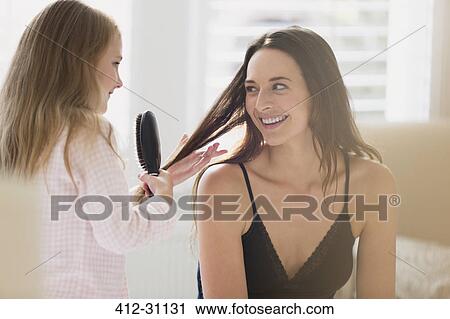 Daughter brushing mothers hair View Large Photo Image Stock Image - Daughter brushing mothers hair. Fotosearch