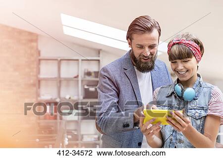 Stock Image - Design professionals using digital tablet in office. Fotosearch