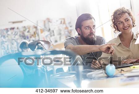 Design professionals using graphics tablet working in office View Large Photo Image Stock Photo - Design professionals using graphics tablet working in office. Fotosearch