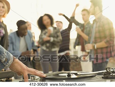 DJ spinning record at rooftop party View Large Photo Image Stock Photograph - DJ spinning record at rooftop party. Fotosearch