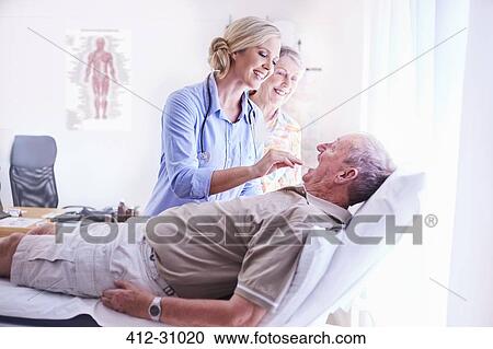 Doctor examining senior mans mouth at checkup View Large Photo Image Stock Image - Doctor examining senior mans mouth at checkup. Fotosearch