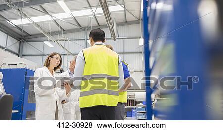 Engineers and worker talking in steel factory View Large Photo Image Stock Photo - Engineers and worker talking in steel factory. Fotosearch