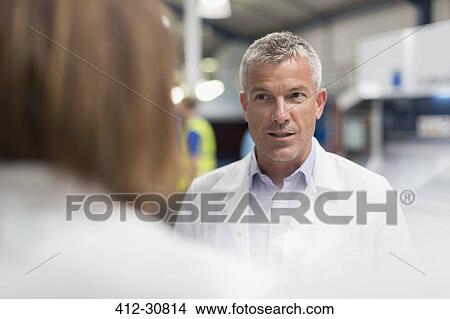 Picture - Engineers talking in steel factory. Fotosearch