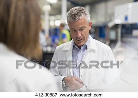 Engineers talking in steel factory View Large Photo Image Stock Photo - Engineers talking in steel factory. Fotosearch