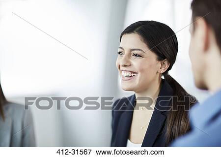 Stock Photo - Enthusiastic businesswoman in meeting. Fotosearch