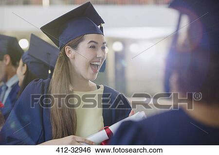 Enthusiastic female college graduate in cap and gown View Large Photo Image Stock Photograph - Enthusiastic female college graduate in cap and gown. Fotosearch