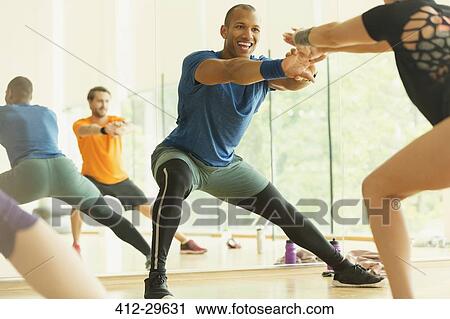 Enthusiastic fitness instructor leading aerobics class View Large Photo Image Stock Image - Enthusiastic fitness instructor leading aerobics class. Fotosearch