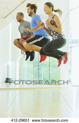 Enthusiastic men and woman jumping in exercise class View Large Photo Image Stock Image - Enthusiastic men and woman jumping in exercise class. Fotosearch
