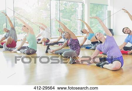 Picture - Exercise class stretching arms. Fotosearch