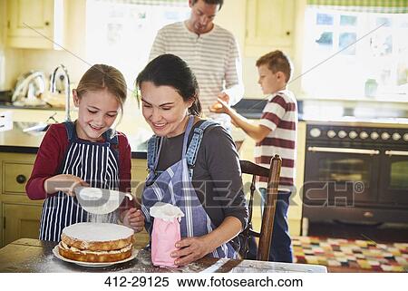 Stock Photography - Family baking cake in kitchen. Fotosearch