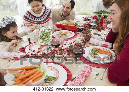 Stock Image - Family enjoying Christmas dinner. Fotosearch