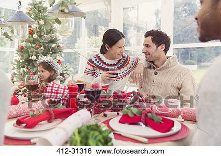Stock Photograph - Family enjoying Christmas dinner. Fotosearch